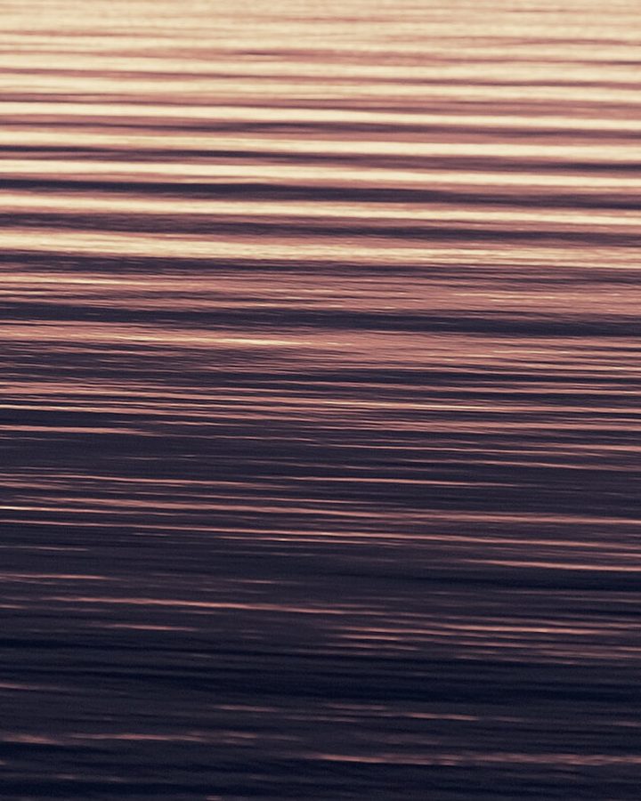 Soft ripples spreading across still water
